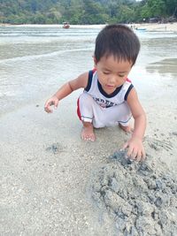 High angle view of boy playing on beach