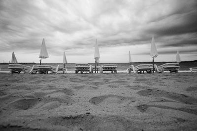 Boats in sea against cloudy sky