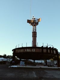 Low angle view of windmill against clear blue sky