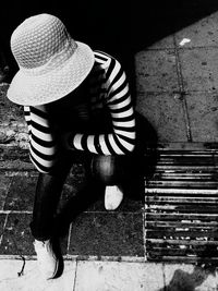 Rear view of woman with umbrella walking on street