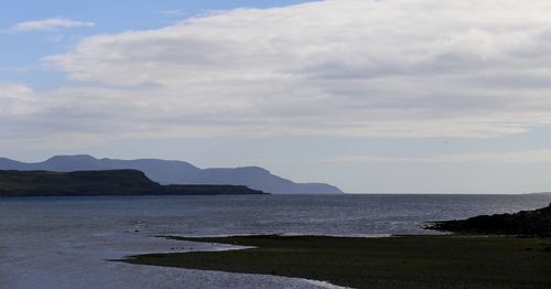 Scenic view of sea against cloudy sky