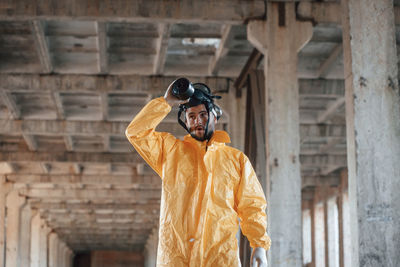 Rear view of man standing against wall