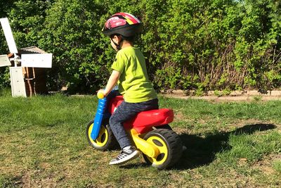 Boy riding bicycle on grass