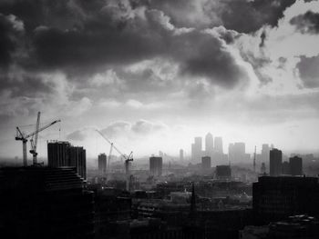 Silhouette of crane against cloudy sky