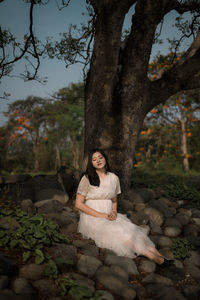 Portrait of a smiling young woman sitting outdoors