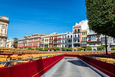 Buildings in city against clear blue sky