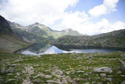 Scenic view of lake and mountains against sky