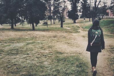 Woman standing on grassy field
