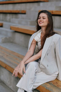 Portrait of young woman sitting outdoors