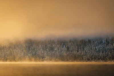Scenic view of landscape against sky during winter