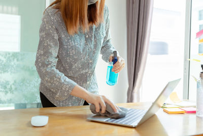 Woman working on table at home