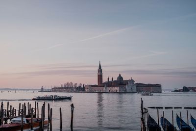 View of buildings at waterfront against sky