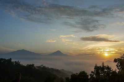 Scenic view of silhouette mountains against sky during sunset