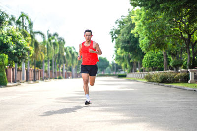 Full length of young woman walking on road