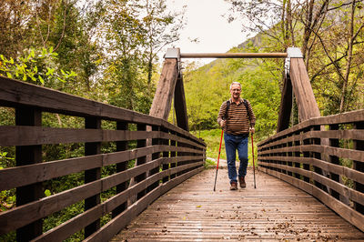 Full length of man standing on footbridge