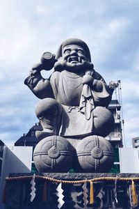 Low angle view of statue against sky