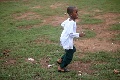 Full length of boy standing on field