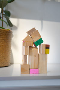 Wooden block toy house on a white background. conceptual image of acquisition of housing.