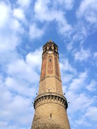 Low angle view of clock tower against cloudy sky