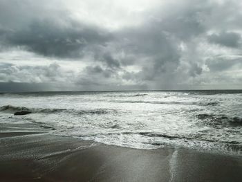 Scenic view of sea against cloudy sky