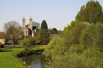 Scenic view of lake by buildings against sky