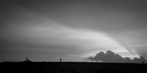 Scenic view of silhouette field against sky