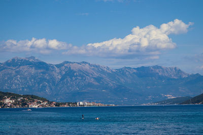 Scenic view of sea and mountains against sky