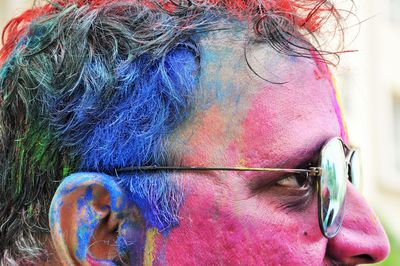 Side view of man face with colorful powder paint 