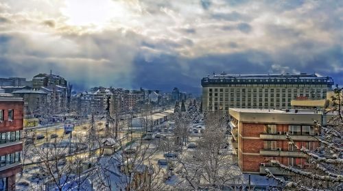 Buildings against cloudy sky