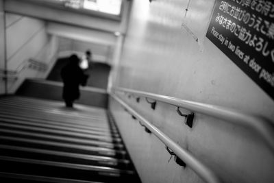 Low angle view of man walking in corridor