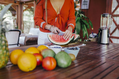 Man holding fruits on table