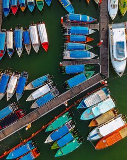 High angle view of multi colored boats moored at harbor in lake