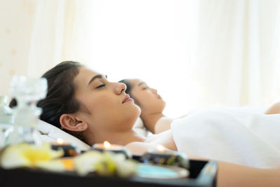 Young women relaxing on massage tables in spa