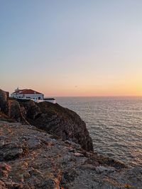 Scenic view of sea against clear sky at sunset