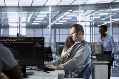 Side view of business colleagues working in office
