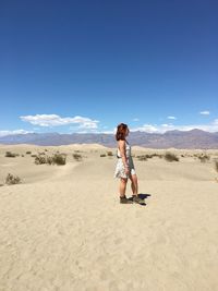 Full length of woman on sand dune