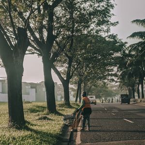 Rear view of man walking on field