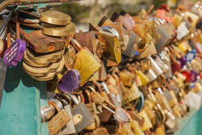 Close-up of love locks hanging on railing