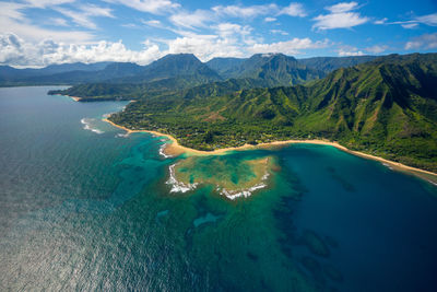 Aerial view of sea and mountains against sky