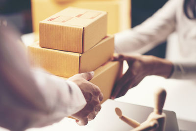 Close-up of man receiving delivery of boxes