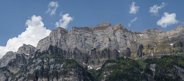 Low angle view of rocky mountains against sky