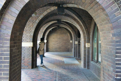 Rear view of man walking on building