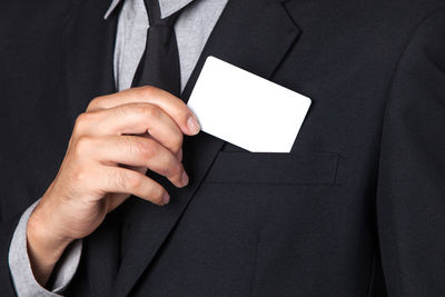 Close-up of man holding business card