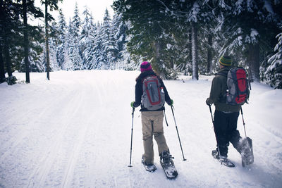 Couple snowshoeing in forest