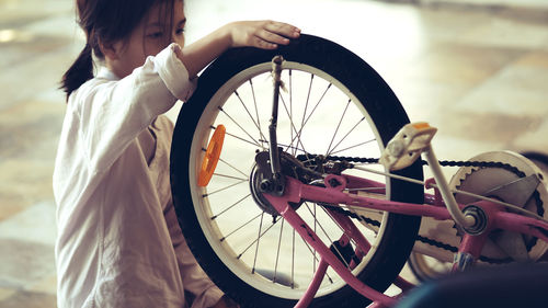 Side view of woman riding bicycle