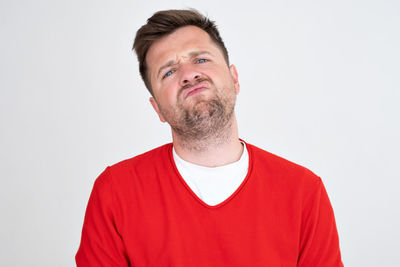 Portrait of young man against white background