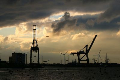 Commercial dock against cloudy sky