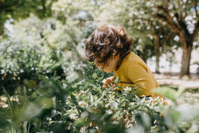 Side view of woman on flowering plants