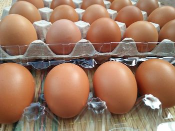 High angle view of brown eggs in crate