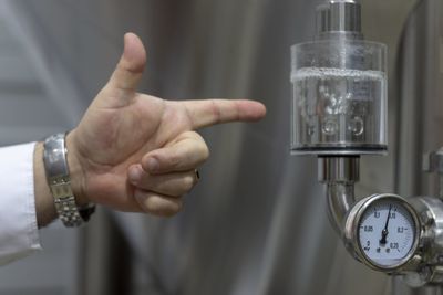 Close-up of hand holding clock